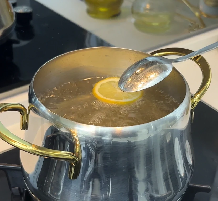 Measuring sugar and water and turning them into baklava syrup in a saucepan