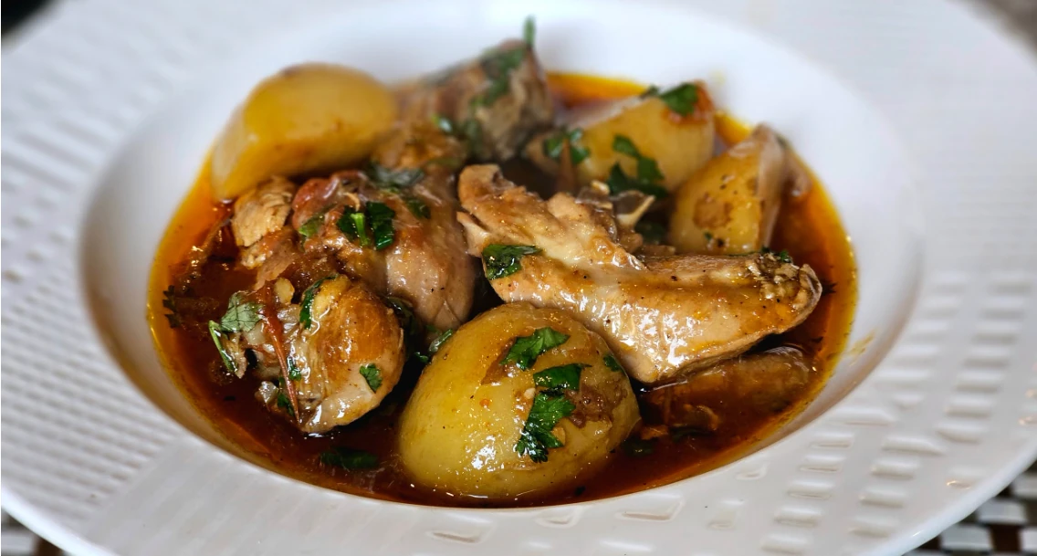 Chicken and large potato cubes in a tomato and pepper paste sauce